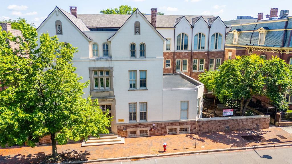 Exterior front view of a white 3 story building